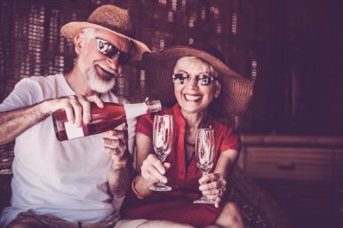 Senior couple enjoying summer vacations with champagne